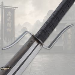 Close-up of sword guard and handle with mountain backdrop