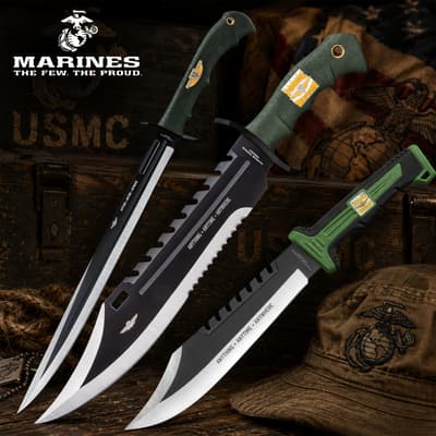 Three tactical knives with USMC branding on a wooden background