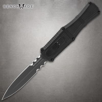 Black serrated knife with textured handle on gray background