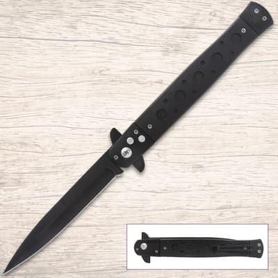 Black stiletto knife on wooden surface