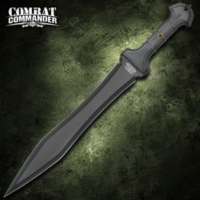 Single black tactical knife with a textured handle on a green background