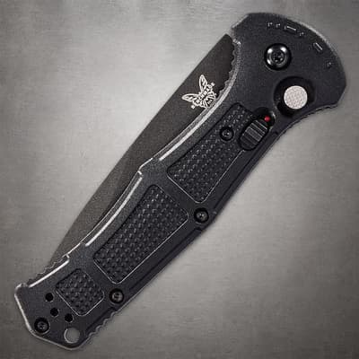 Closed black folding knife with textured grip