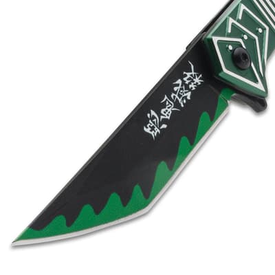 Close-up of knife blade with green wave pattern