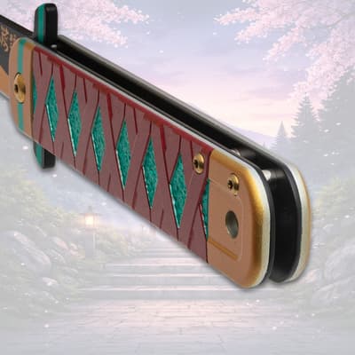 Close-up of folded knife handle with red and teal design