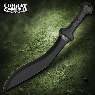 Black tactical knife with a curved blade and textured handle on a green background
