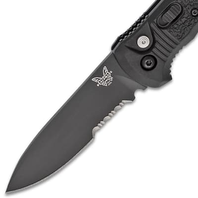 Close-up of a black serrated knife blade with logo