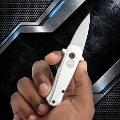 Hand holding a silver automatic knife