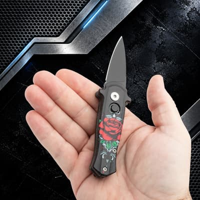 Small knife with rose design held in hand