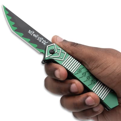 Hand holding green folding pocket knife