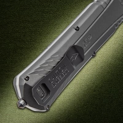 Close-up of knife handle with caution text on textured background