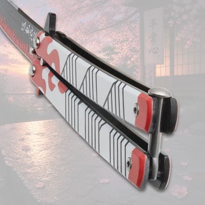 Close-up of butterfly knife handle with flame design