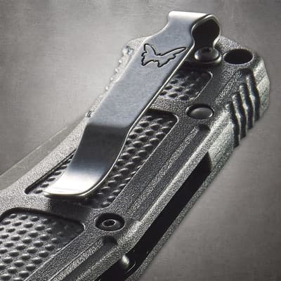 Close-up of knife handle with metal clip and logo
