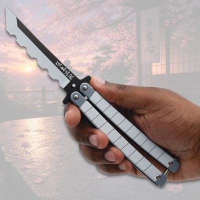 Hand holding an open butterfly knife with scenic background