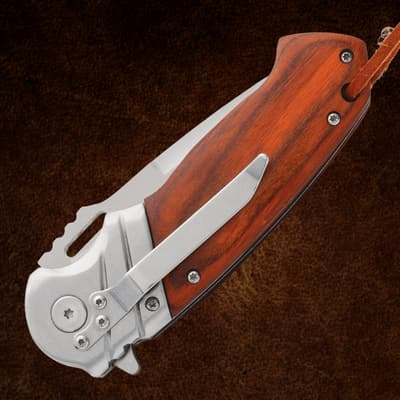 Folded Timber Wolf pocket knife showing wood handle and clip