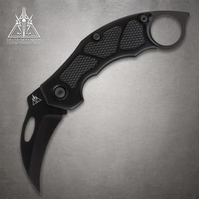 Black folding knife with textured grip and ring handle