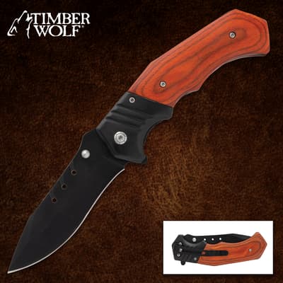 Folding knife with wooden handle on brown background