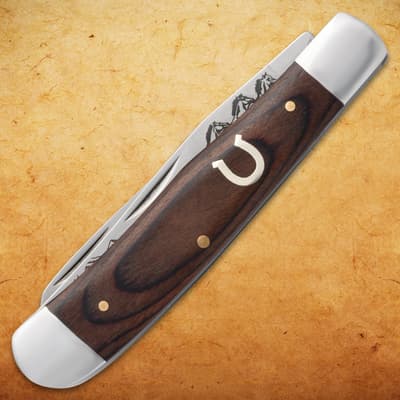 Closed pocket knife with wooden handle and horseshoe inlay