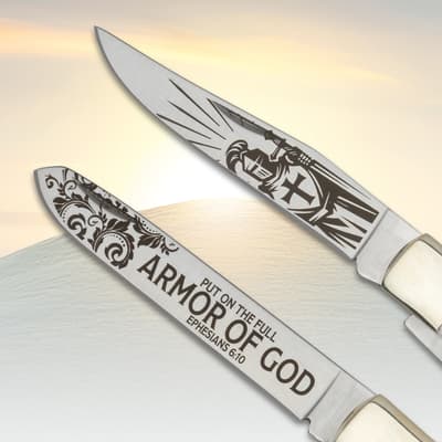 Close-up of knife blades with religious engravings