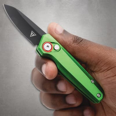 Hand holding a green folding knife with black blade