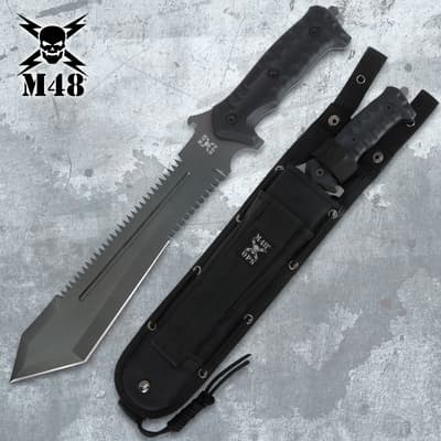 Serrated tactical knife with sheath on a textured surface