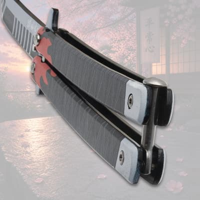 Close-up of butterfly knife handle with flame design