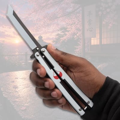 Hand holding a butterfly knife with scenic background