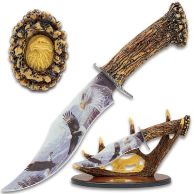 Decorative knife with eagle design and antler handle, displayed on a stand