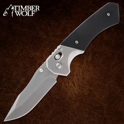 Silver folding knife with black handle on brown background