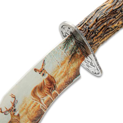 Close-up of knife blade with deer illustration