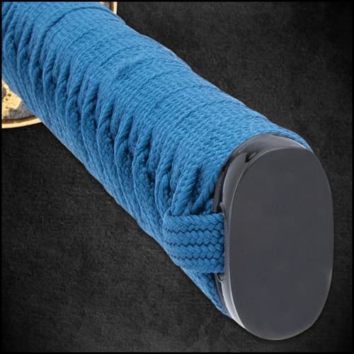 Damascus steel blue blade extended from a dragon metal handguard and genuine rayskin handle wrapped with a nylon blue cord