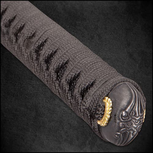 A close view of a black katana scabbard with a black and gold knob wrapped with a black cord