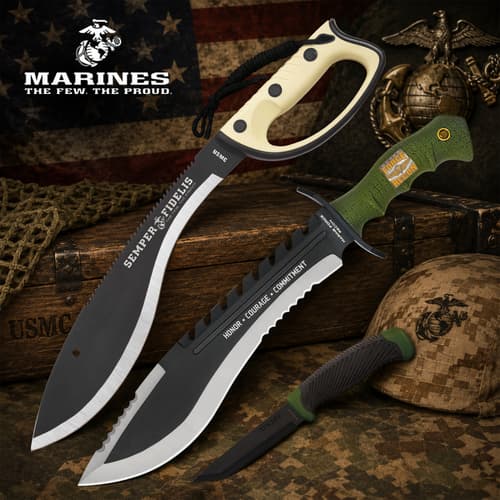 Three USMC knives on a wooden surface with military symbols