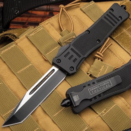 Black tactical knife on tan military gear