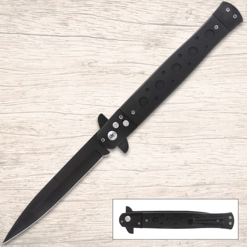 Stiletto knife on wooden surface