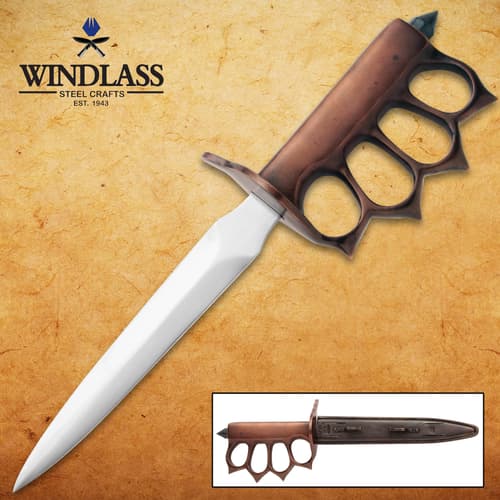 Trench knife with brass knuckle handle on textured background