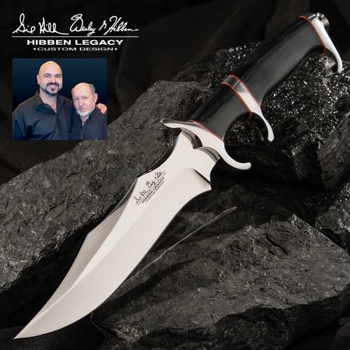 Legacy III fighter knife with black, silver, and red accents on a background of black rocks.