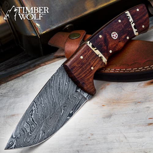 Damascus steel knife with wooden handle on leather sheath