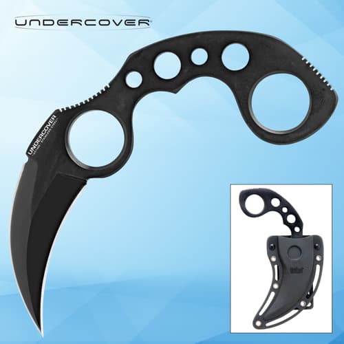 Black karambit knife with sheath on blue background