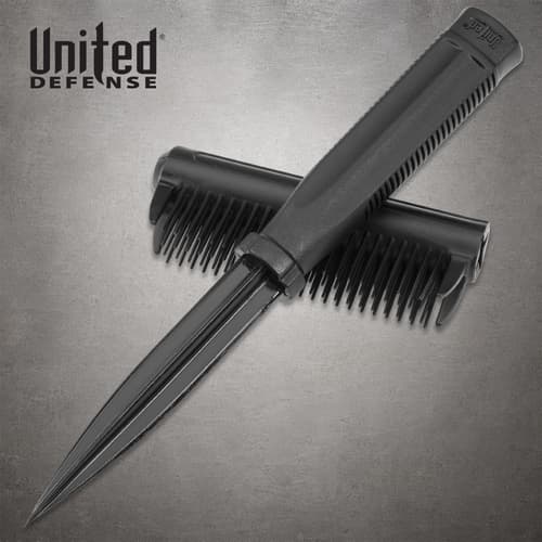 Black Dapper Defender brush knife with exposed dagger blade resting across its detached brush cover