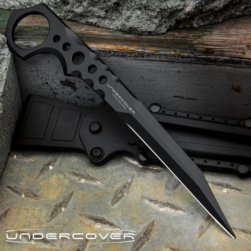 Slim black 7 1/4" stinger knife with an open ring pommel and the text "UNDERCOVER" displayed in the center of the knife and in the bottom left corner.