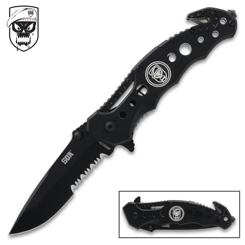 Folding knife with skull logo and serrated blade