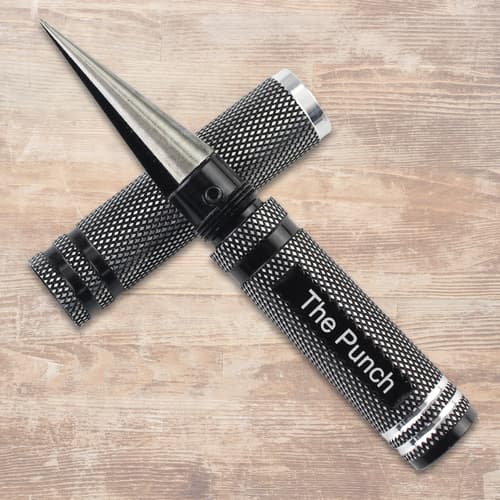 Metal punch tool with textured grip on wooden surface