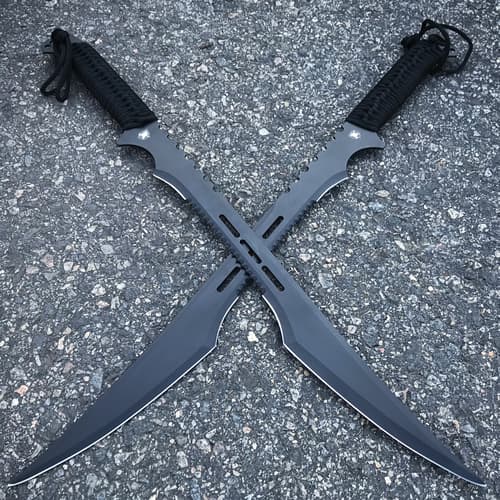 Secret Agent dual swords with black blades and black cord wrapped handles are laid across each other on pavement.