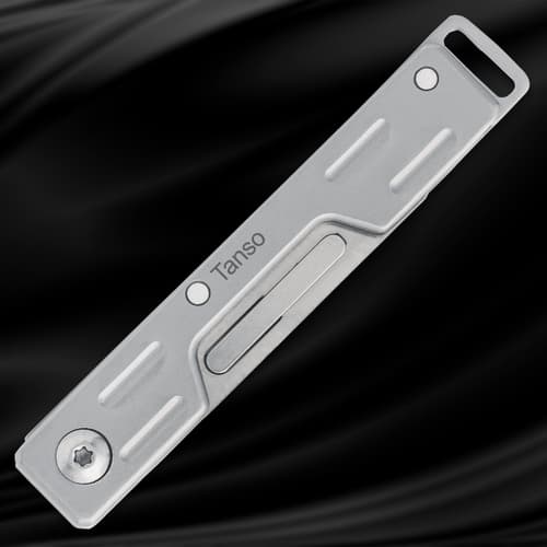 Closed silver folding knife on black background