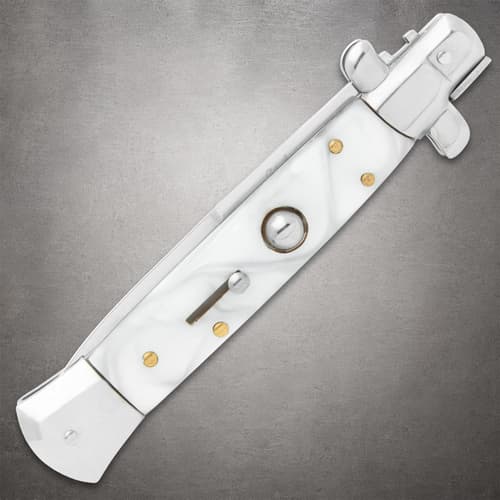 Closed white pearl stiletto knife on gray background