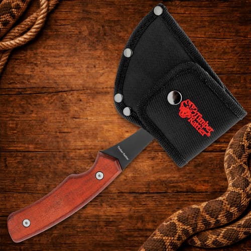 Axe with wooden handle in black sheath on wood