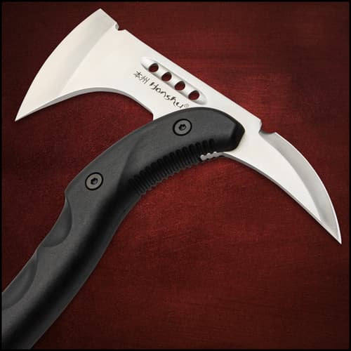 Black tomahawk axe with its head enclosed with a black leather sheath and its black textured nylon handle exposed on a white background.