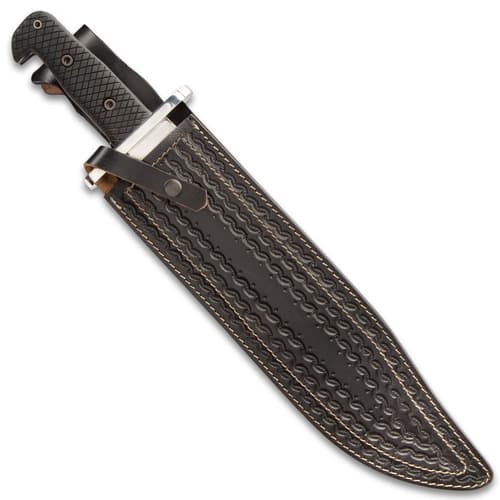 Large knife in a dark brown leather sheath with various intricate stamped details and a snap button closure.