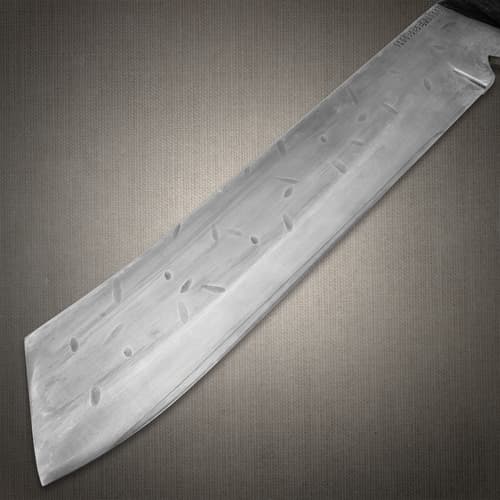 Close-up of machete blade with engraved patterns
