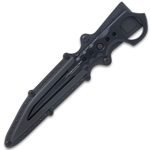 Black "Undercover" stinger knife being held through the open ring pommel in front of black knife sheath attached to utility jacket.